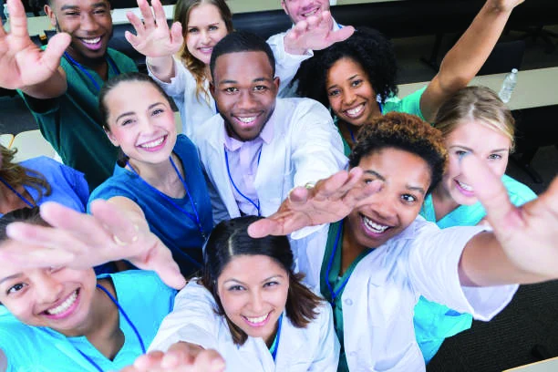 A diverse group joining hands.